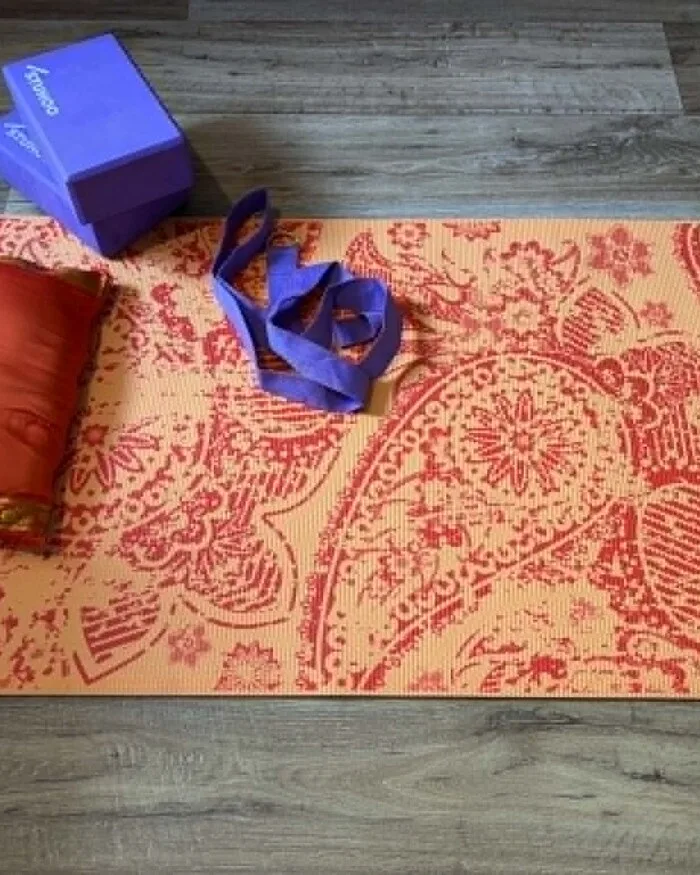 A yoga mat, blocks and strap laid out ready for a gentle session