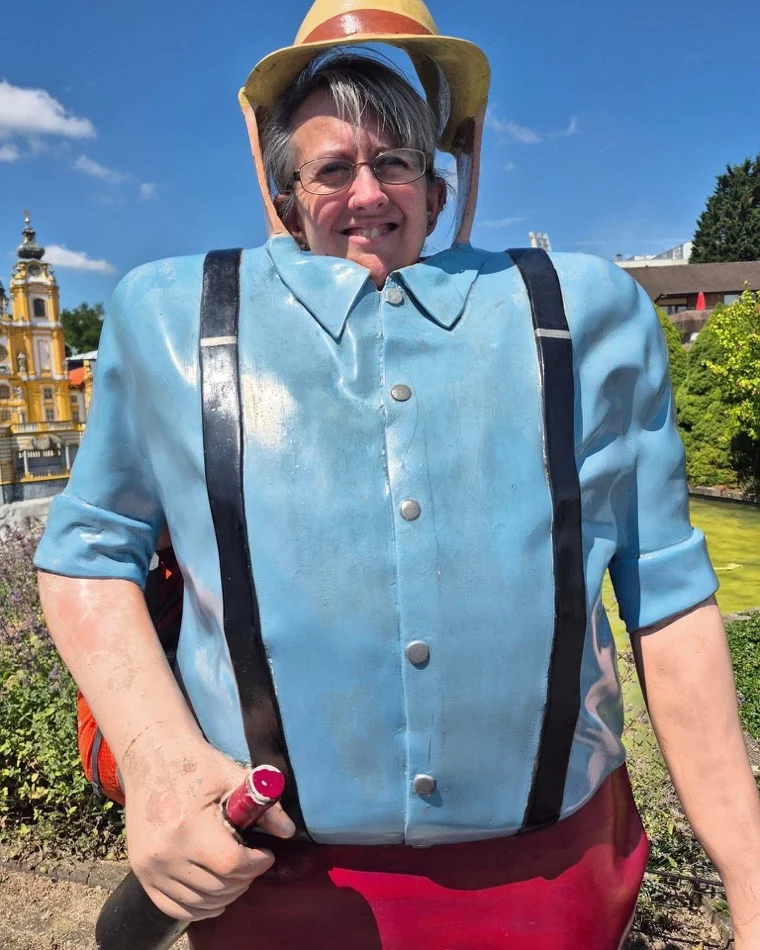 Anne having fun posing behind a seaside character cut-out board